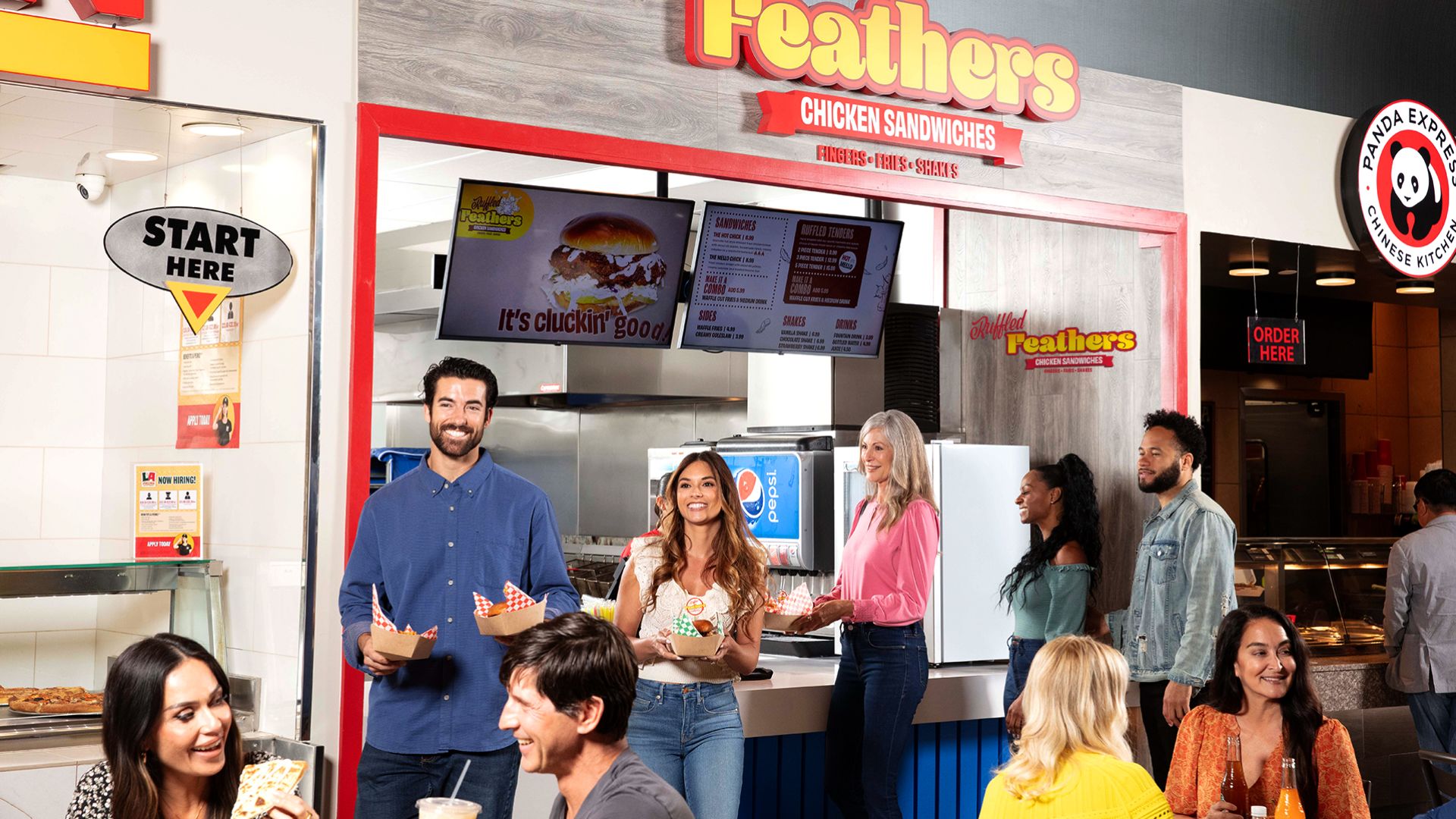 A Group Of People Standing In A Restaurant