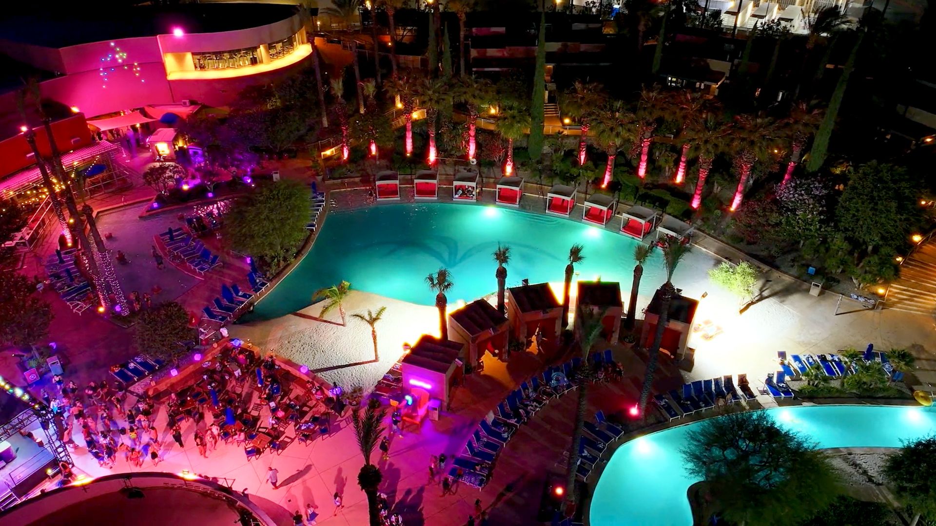 A Pool With A Crowd Of People Around It